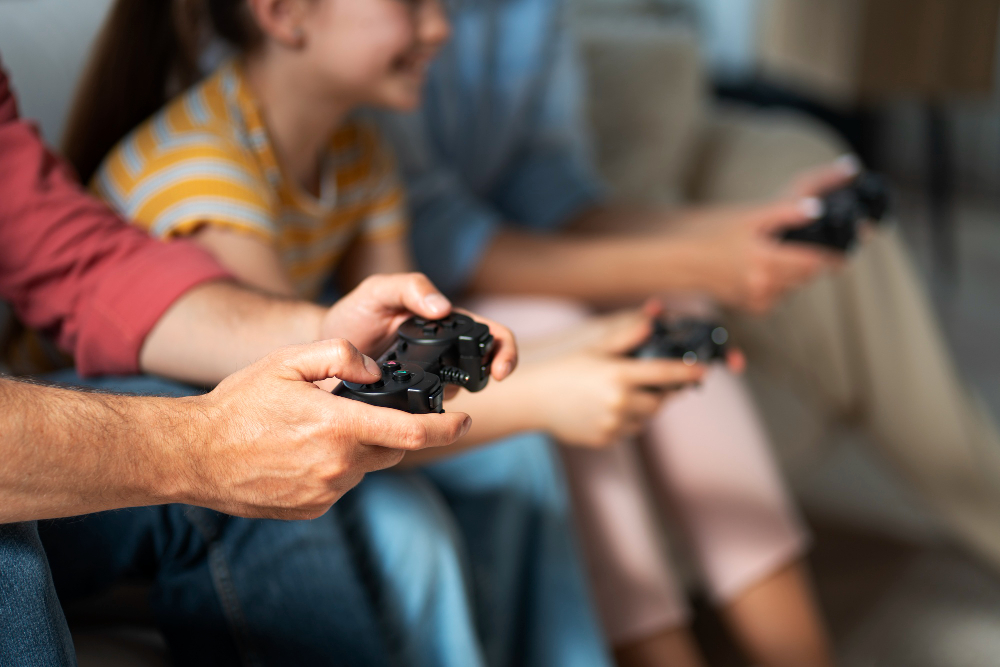 side view family playing videogame 1 Bragg Gaming Group Second Quarter Revenue Rises 18.9% to Record €24.7 Million (USD $27.2 Million)